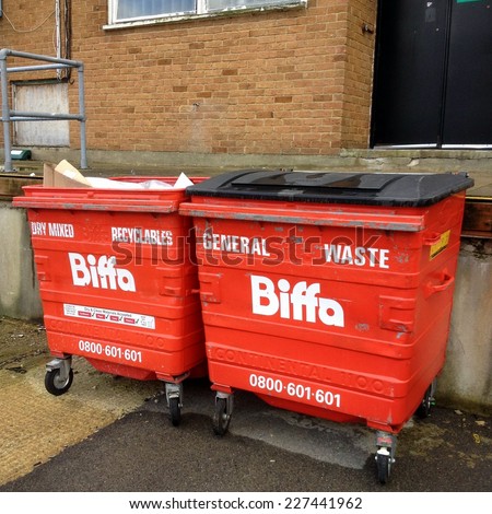 Bracknell, United Kingdom - November 1st, 2014: Two red Biffa wheelie bins awaiting collection. Biffa is the UK\'s leading waste management business for collection, treatment and recycling