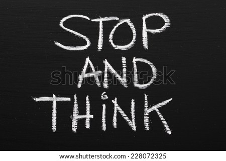 The phrase Stop and Think written on a blackboard as a reminder to take time out and work through our options before taking action