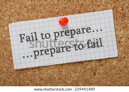 A reminder that if you fail to prepare you are preparing to fail typed on a piece of graph paper pinned to a cork notice board. Advice on the difference between failure and success.
