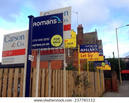 Reading, United Kingdom - December 11th, 2014: Estate Agency or Real Estate business advertising signs crowded together in a residential district of Reading, England on December 11th 2014