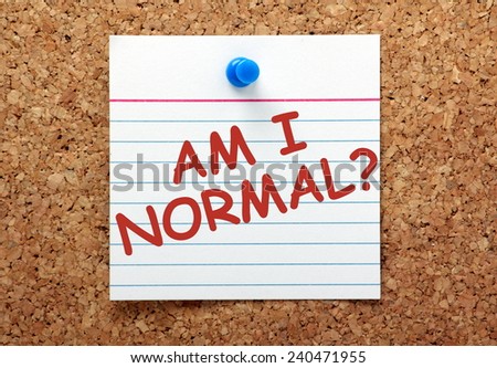 The question Am I Normal in red ink on a lined note card pinned to a cork notice board