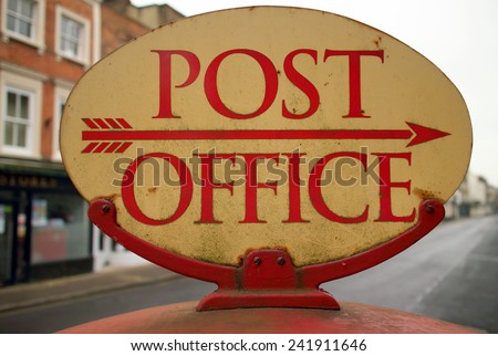 Vintage Post Office sign in the high street of a town with an arrow pointing in the right direction
