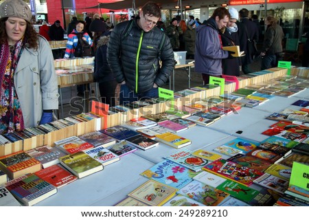 London, England - January 24, 2015: People browsing the books for sale at the Southbank Centre Book Market in London, England. Located beneath the Waterloo Bridge the market is open all year round.