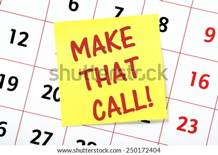 The phrase Make That Call written on a yellow sticky note and on a wall calendar
