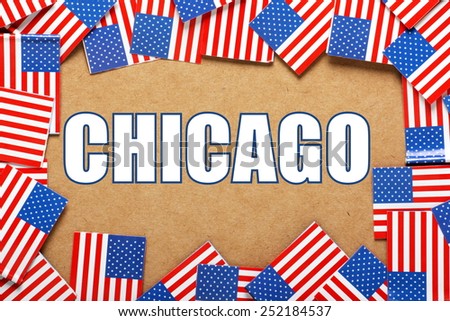 Miniature flags of the United States of America form a border on brown card around the name of the city of Chicago