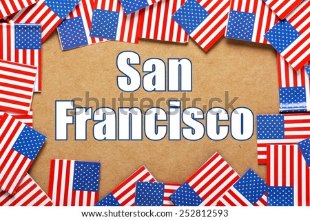 Miniature flags of the United States of America form a border on brown card around the name of the city of San Francisco