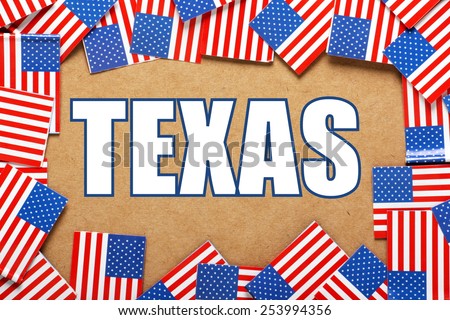 Miniature flags of the United States of America form a border on brown card around the name of the state of Texas