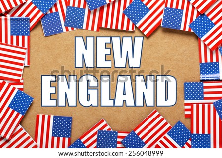 Miniature flags of the United States of America form a border on brown card around the name of the region of New England