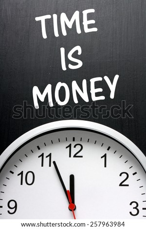 The phrase Time Is Money written on a blackboard above a clock face with the time at almost midnight