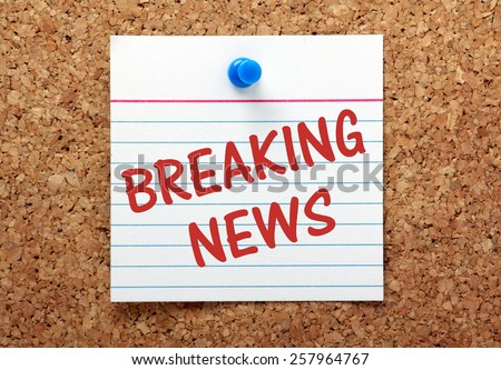 The phrase Breaking News on a lined index card pinned to a cork bulletin board