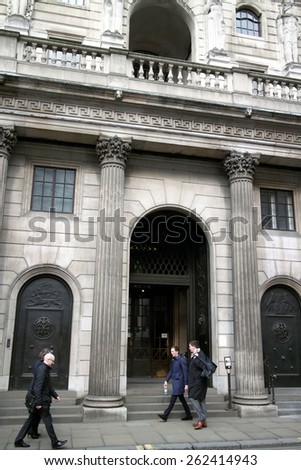 London, England - March 17, 2015: People passing by the street entrance of the Bank Of England in London. Also known as The Old Lady of Threadneedle Street, the bank was founded in 1694