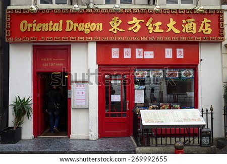 London, United Kingdom - April 16, 2015: People entering the Oriental Dragon Restaurant in Chinatown, London. There are more than eighty restaurants in the Chinatown District.