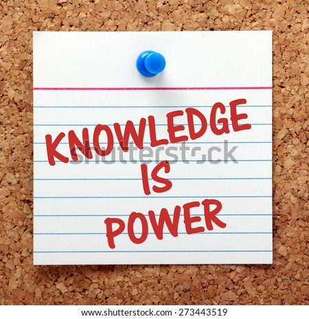 The phrase Knowledge Is Power in red text on a white index card pinned to a cork notice board