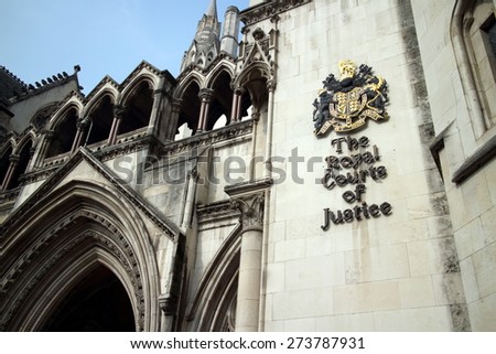 London, England - March 17, 2015: Part of the exterior facade of the Royal Courts of Justice in London, England showing the coat of arms of the courts and architectural details
