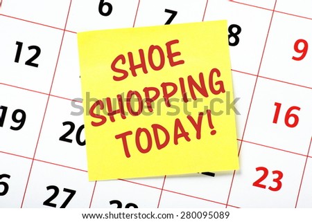 A reminder to go Shoe Shopping Today on a yellow sticky note attached to the page of a calendar