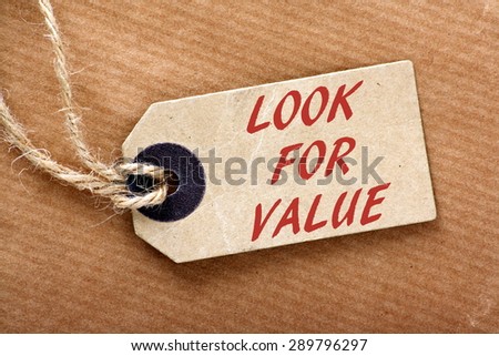 The phrase Look For Value in red text on a price or luggage tag with string on brown wrapping paper
