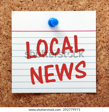 The phrase Local News in red text on an index card pinned to cork notice board as a reminder