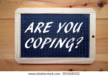 The question Are You Coping? in white text on a slate blackboard