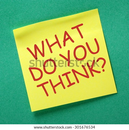 The question What Do You Think? in red text on a yellow sticky noted posted on a green notice board