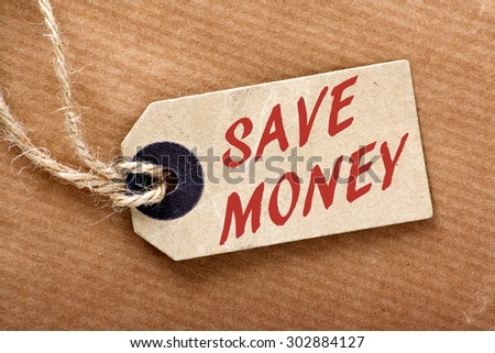 The words Save Money in red text on a price tag or label with string and brown wrapping paper