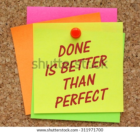 The phrase Done Is Better Than Perfect in red text on a yellow sticky note pinned to a cork notice board as a reminder it is sometimes better to get a product to market than waiting for perfection.