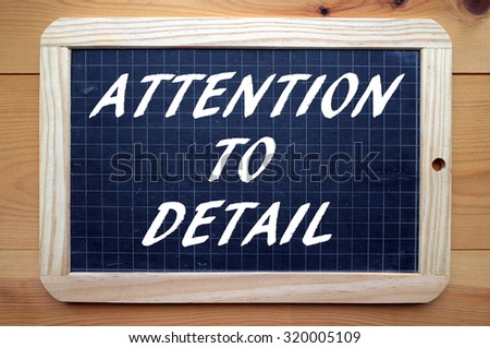 The phrase Attention To Detail in white text on a blackboard as a reminder that the little things are also important in business and life