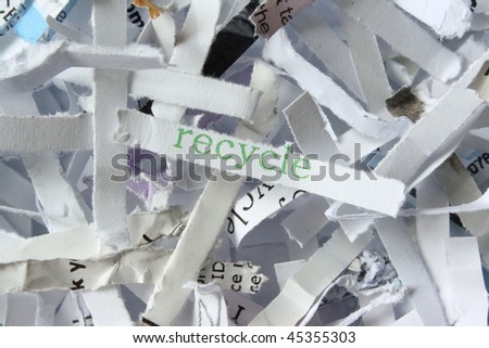 Recycle paper with the keyword in green to emphasise recycling as a means of savings costs and the environment