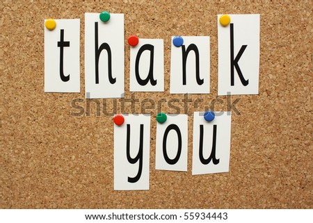The phrase Thank You spelled out in letters pinned to a cork board