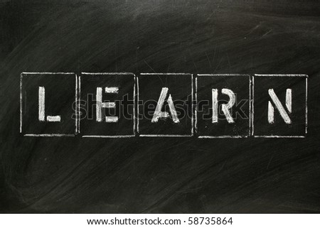 The word LEARN in stencil letters on a blackboard