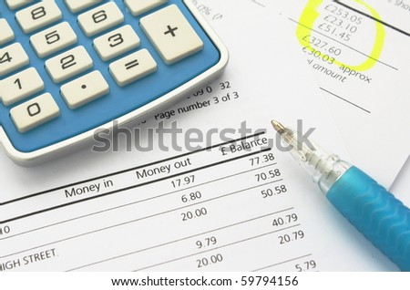 Bank statement and home finance documents with calculator and pen