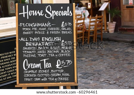 House Special menu board with a street cafe or restaurant in the background