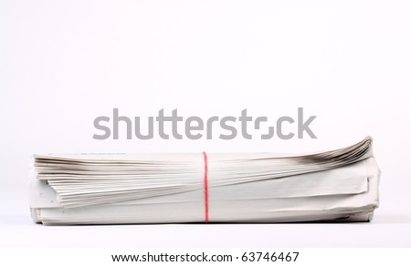 Rolled up newspaper on white background with copy space