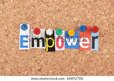 The word Empower in cut out magazine letters pinned to a cork notice board