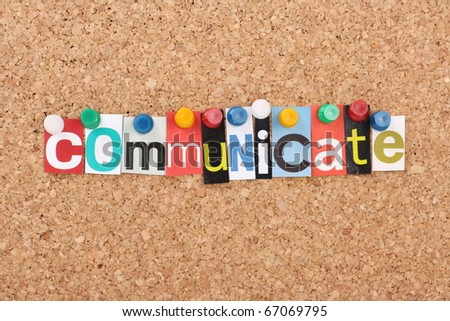 The word Communicate in cut out magazine letters pinned to a cork notice board
