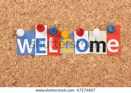 The word Welcome in cut out magazine letters pinned to a cork notice board