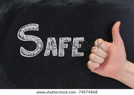 The word Safe written on a used blackboard with a hand giving the thumbs up sign to say yes.