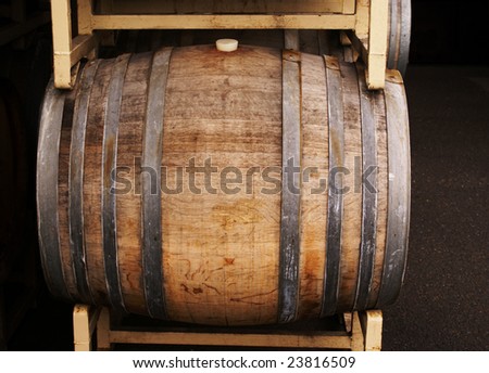 A wine barrel on a yellow rack.