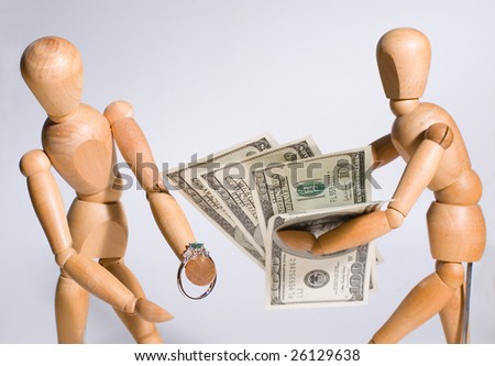 Two wooden artist\'s models hold money and an engagement ring.