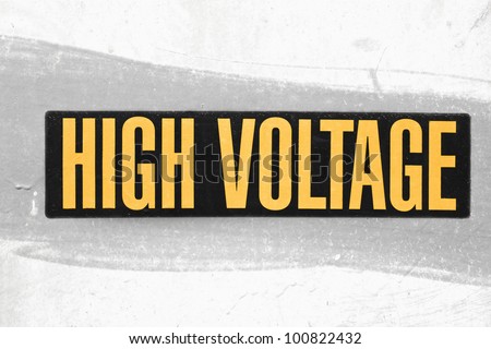 High voltage sign shown in yellow and black.