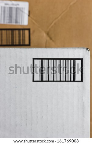 Several bar codes imprinted on boxes stack upon another.