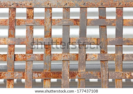 Old rusty metal makes a fence pattern.