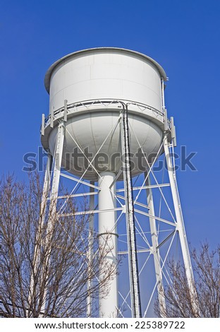 Large water tower stands high in a rural community.