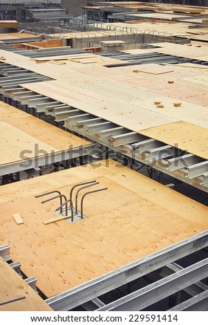 Rebar and metal support beams are used to support a floor under construction.