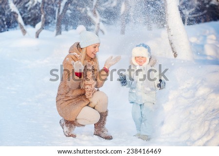 Mother with his Child playing snow