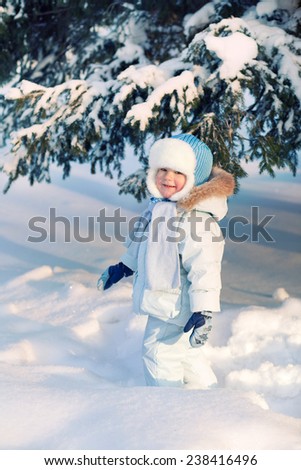 Child shakes off snow trees
