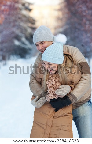 Young family playing in the park in winter