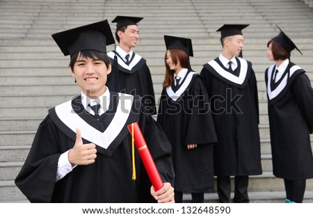 Group of graduation students with Young man with graduation cap and gown and diploma