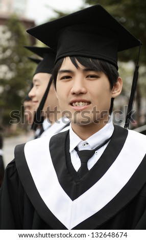 Portrait of Asian graduating student at a campus
