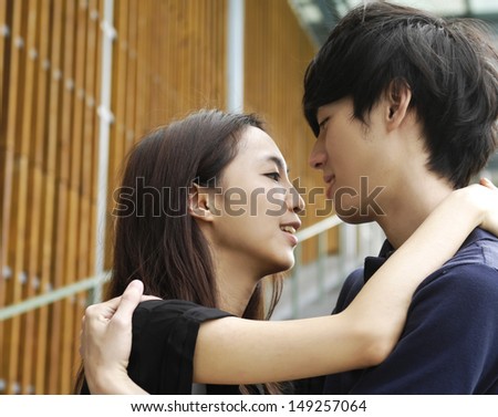 couple on campus embracing each other, have a good time together