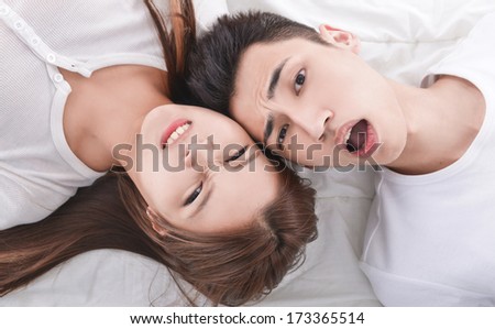 Young man and young woman. Couple sleeping in bed.